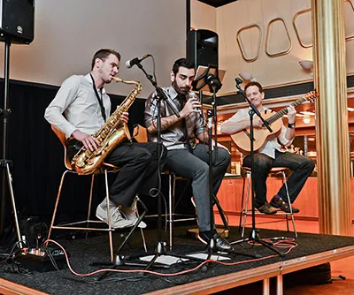 Ferhat Öz with saxophone and guitar